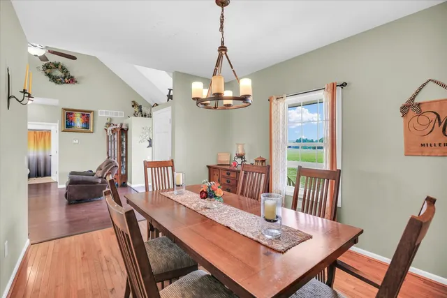 a dining table chairs and a kitchen view