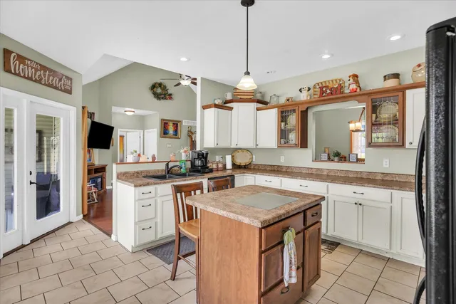 a kitchen with a stove a sink dishwasher and a refrigerator