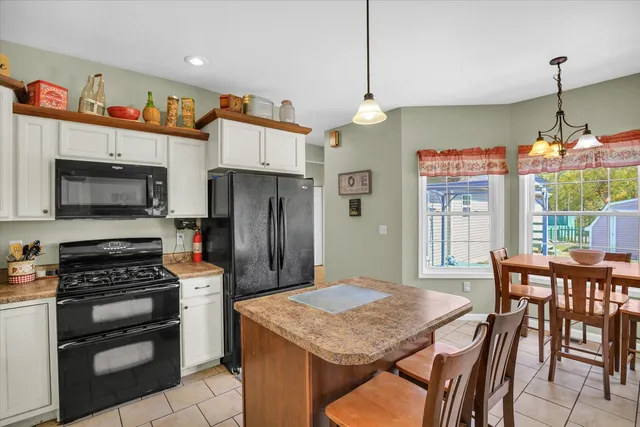 a dining room with furniture a chandelier and window