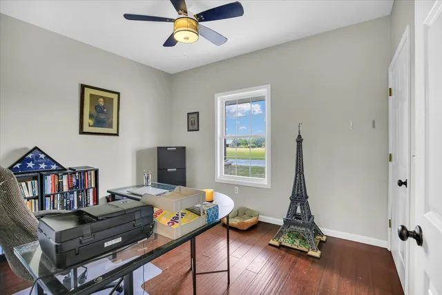 a view of empty room with wooden floor and window