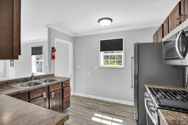 a bathroom with a granite countertop toilet and a sink