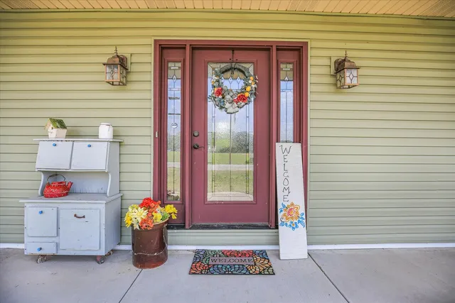 a view of a hallway with wooden floor and a living room