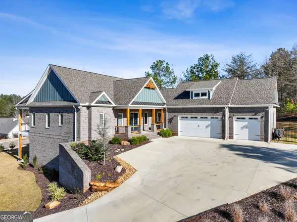 an aerial view of a house with yard swimming pool and outdoor seating