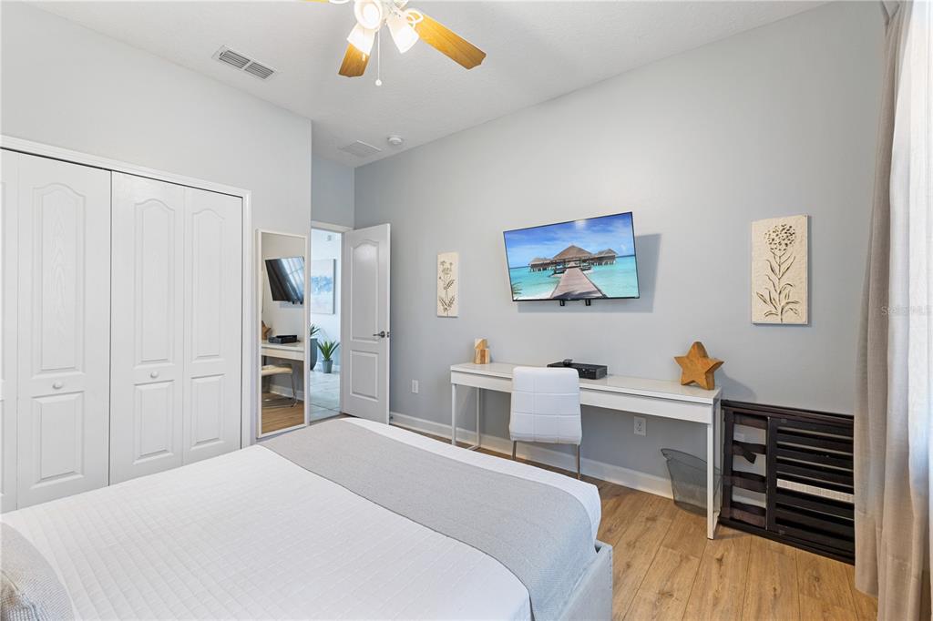 9006 Majesty Palm Road Kissimmee, FL 34747 - Photo 9 of 56 a bedroom with a bed and a chandelier