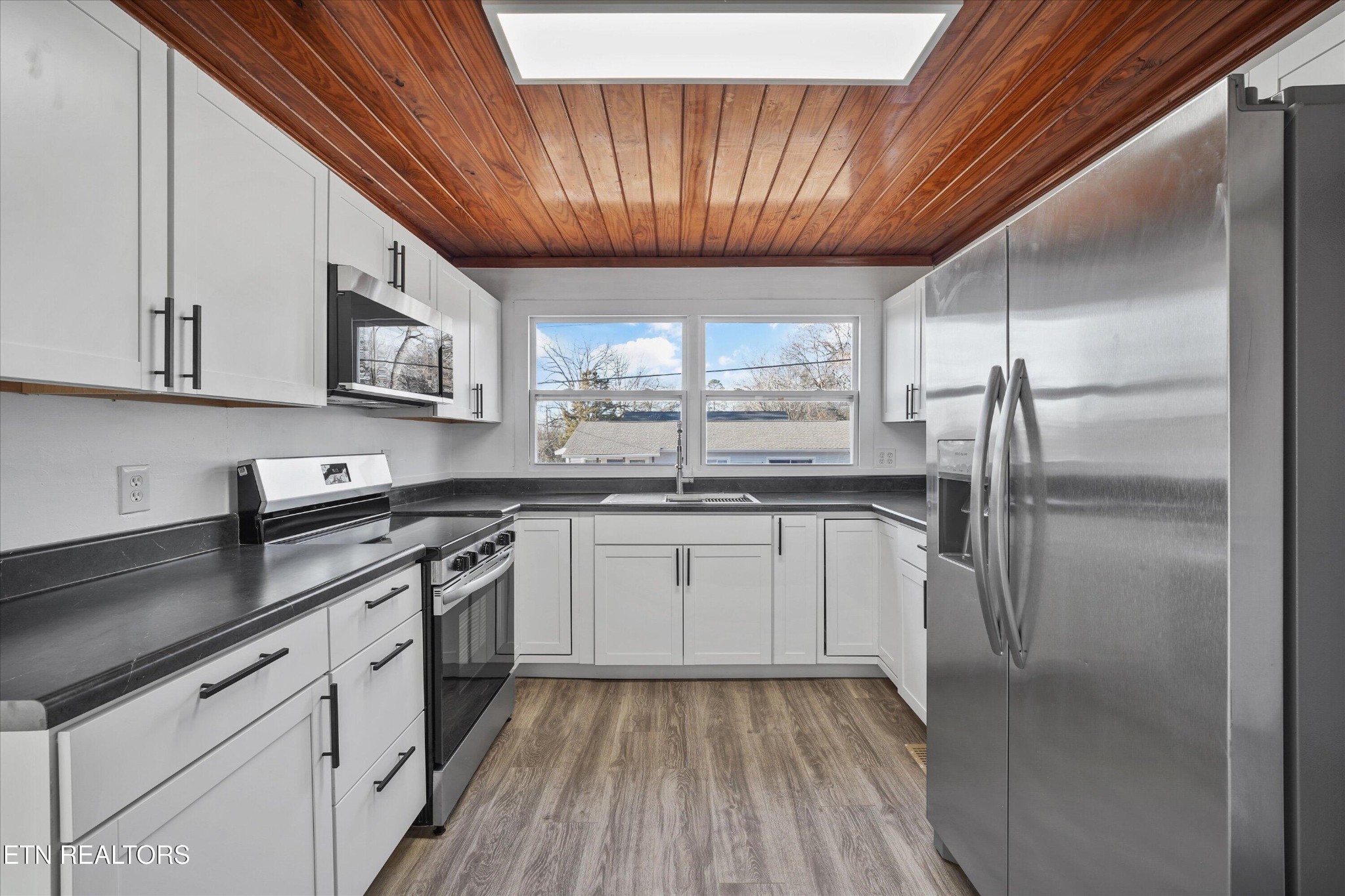 3001 Buffat Mill Road Knoxville, TN 37917 - Photo 14 of 28 a kitchen with kitchen island granite countertop stainless steel appliances a sink stove refrigerator and cabinets
