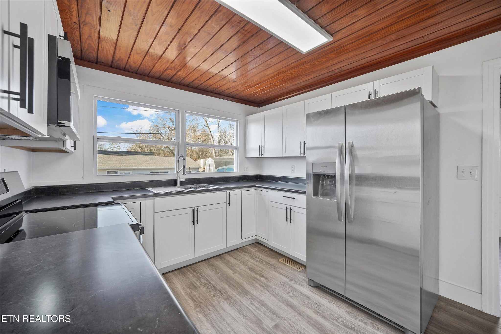3001 Buffat Mill Road Knoxville, TN 37917 - Photo 15 of 28 a kitchen with a refrigerator and white cabinets