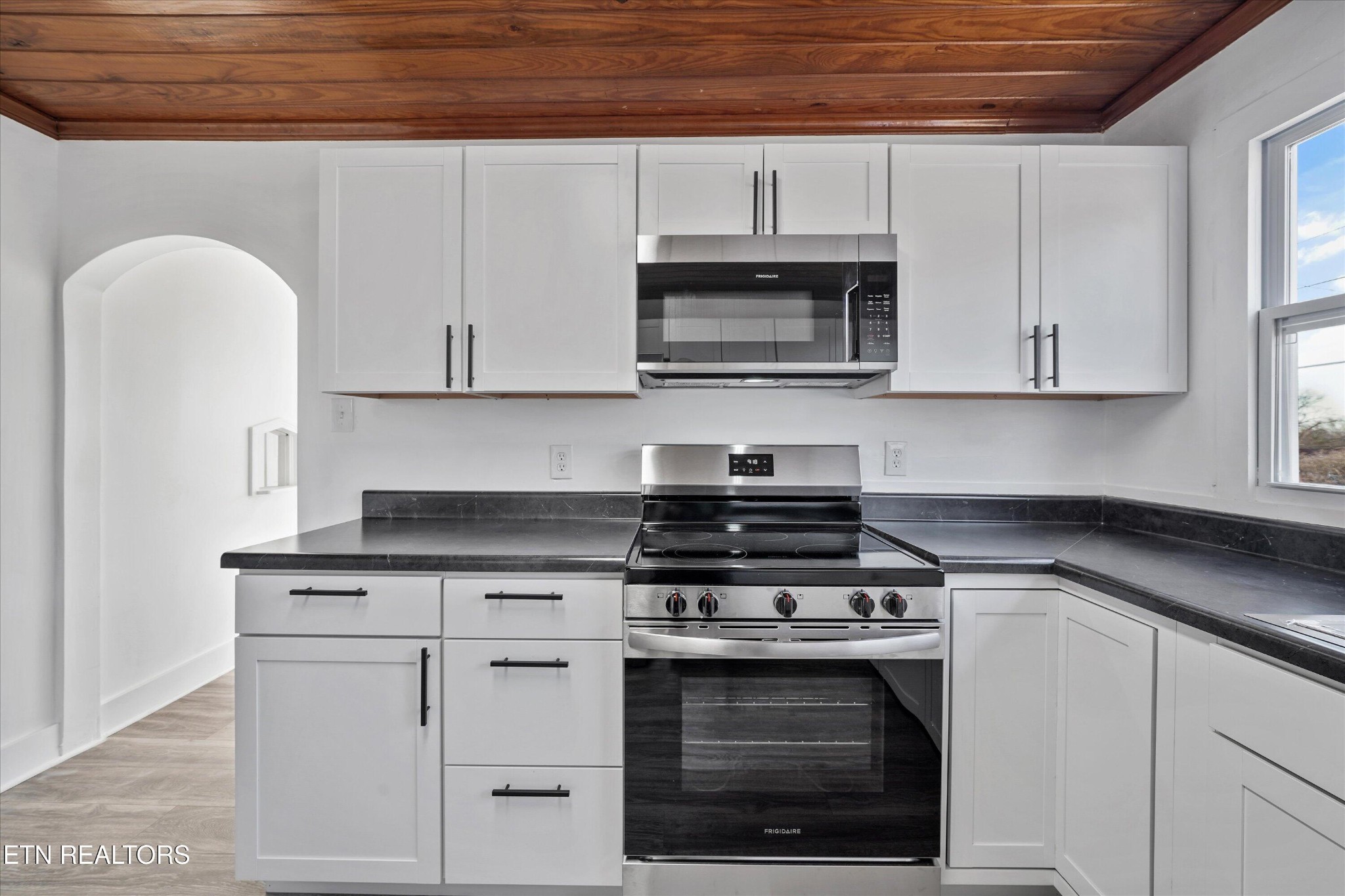 3001 Buffat Mill Road Knoxville, TN 37917 - Photo 16 of 28 a white kitchen with granite countertop white cabinets and stainless steel appliances