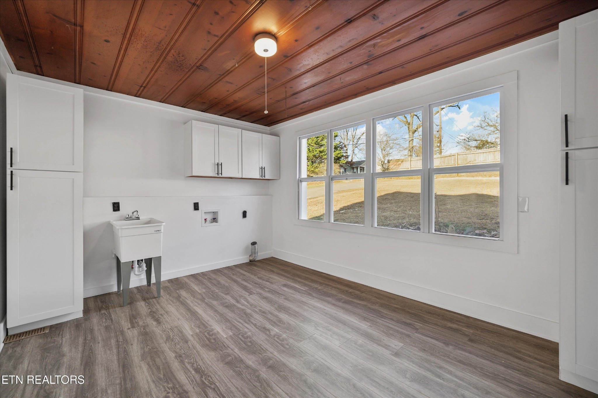 3001 Buffat Mill Road Knoxville, TN 37917 - Photo 20 of 28 a view of an empty room with a window and wooden floor