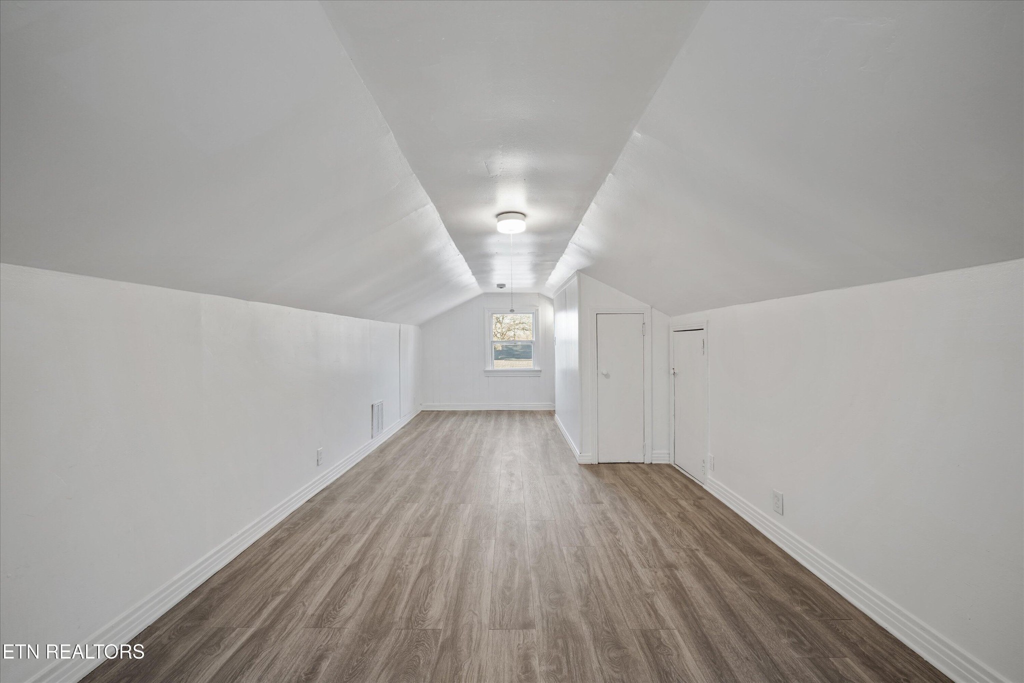 3001 Buffat Mill Road Knoxville, TN 37917 - Photo 22 of 28 wooden floor in an empty room with a window