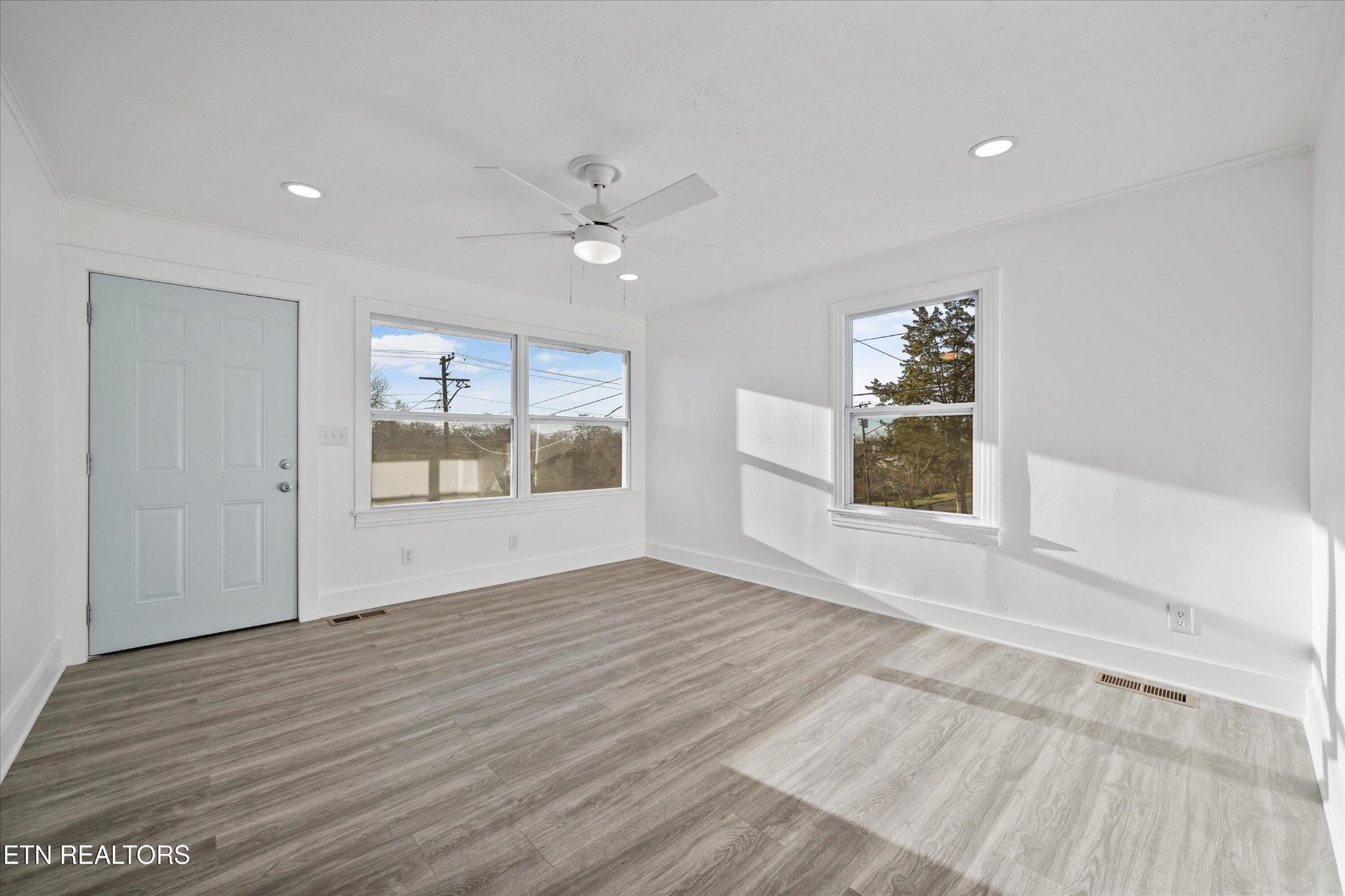 3001 Buffat Mill Road Knoxville, TN 37917 - Photo 7 of 28 a view of an empty room with a window and wooden floor