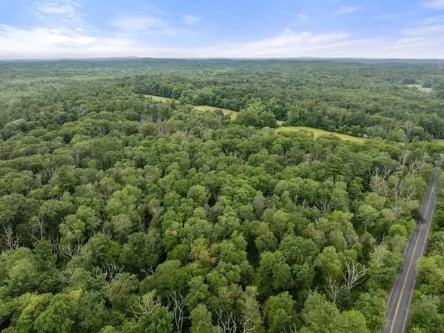 a view of a big yard with lots of green space