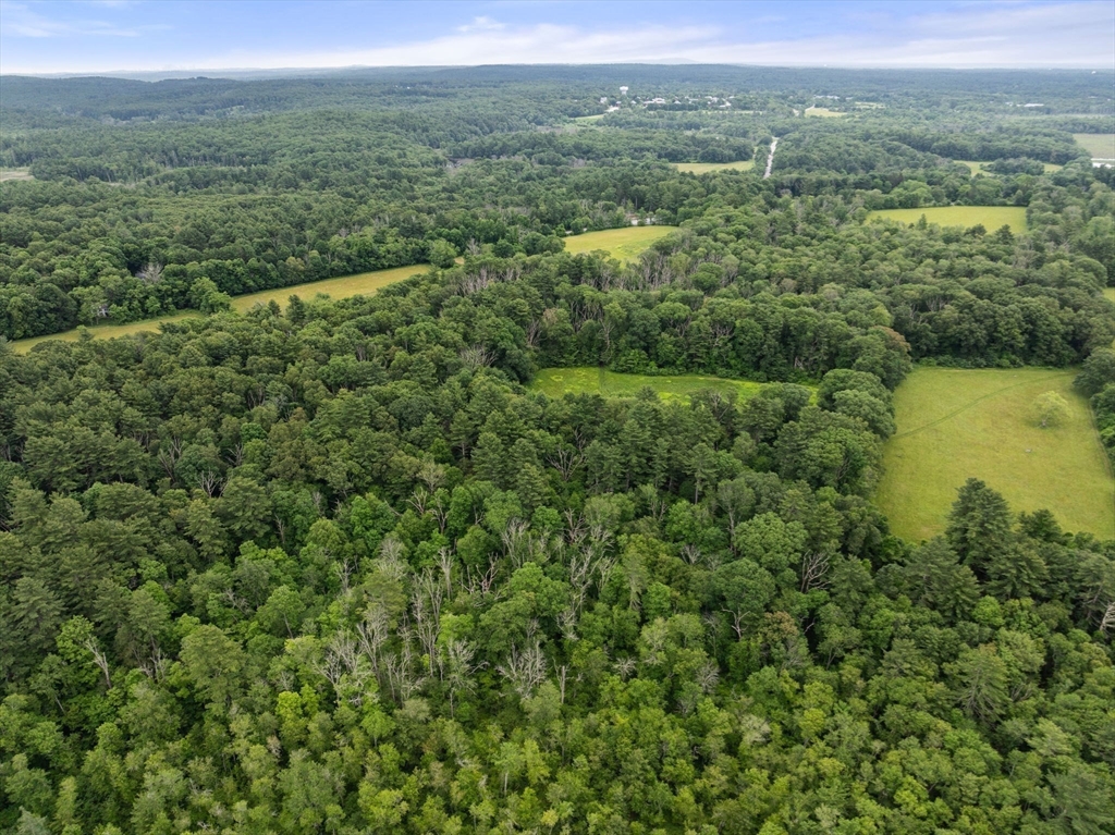 0 South Main Street Sherborn, MA 01770 - Photo 9 of 14 an aerial view of green landscape with trees houses and mountain view