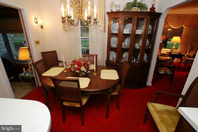 7932 Johnnycake Road Windsor Mill, MD 21244 - Photo 11 of 23 a view of a dining room with furniture and wooden floor