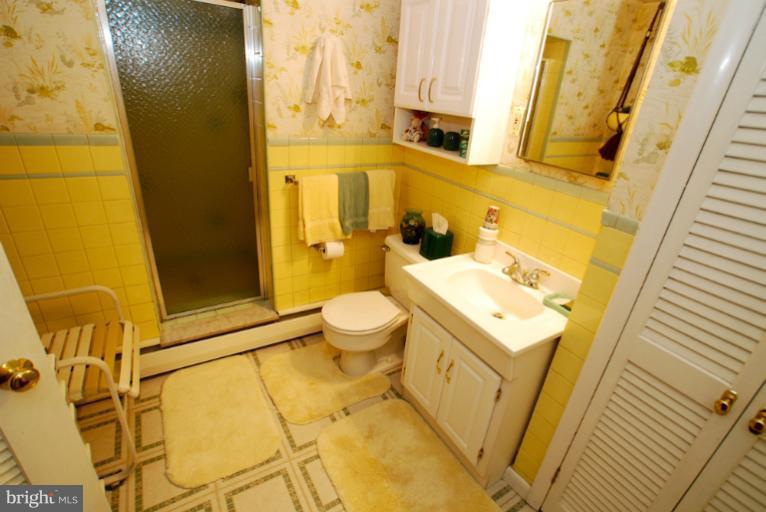 7932 Johnnycake Road Windsor Mill, MD 21244 - Photo 12 of 23 a bathroom with a sink and mirror with toilet