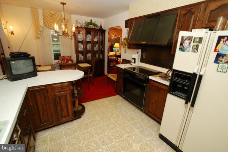7932 Johnnycake Road Windsor Mill, MD 21244 - Photo 15 of 23 a kitchen with a sink appliances and cabinets