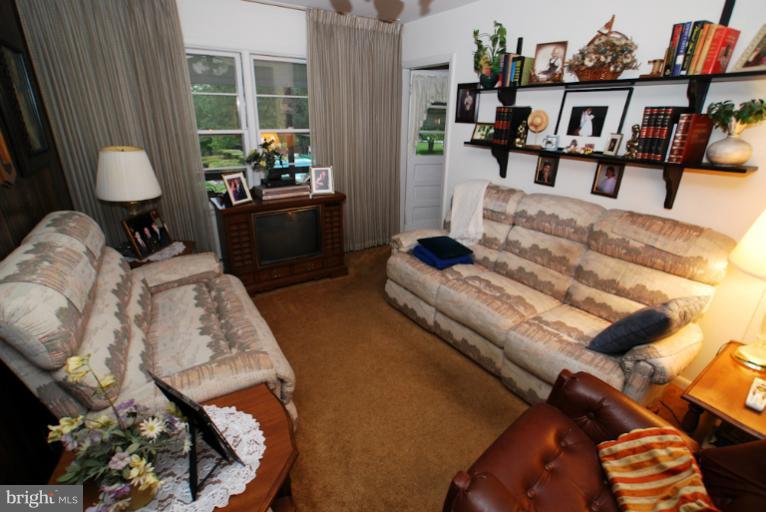 7932 Johnnycake Road Windsor Mill, MD 21244 - Photo 17 of 23 a living room with furniture and a fireplace