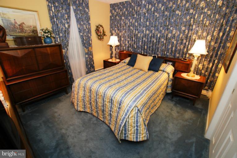 7932 Johnnycake Road Windsor Mill, MD 21244 - Photo 20 of 23 a bed sitting in a bedroom next to a larger window