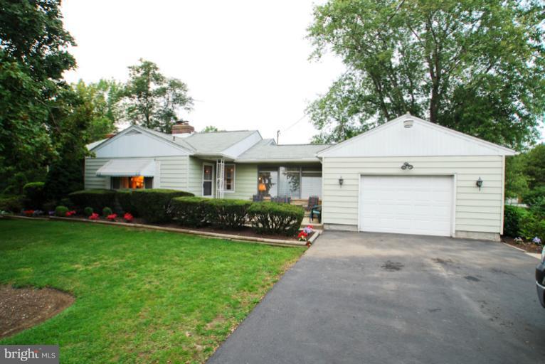 7932 Johnnycake Road Windsor Mill, MD 21244 - Photo 23 of 23 a front view of a house with a yard and garage
