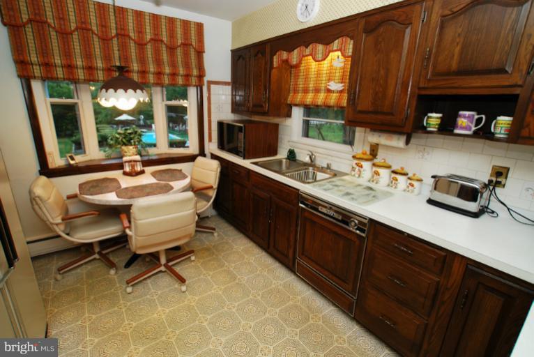 7932 Johnnycake Road Windsor Mill, MD 21244 - Photo 5 of 23 a dining room with a sink and a window