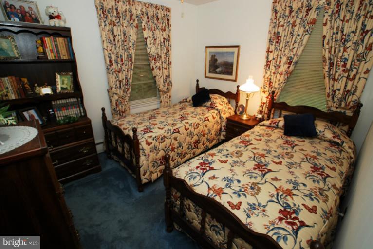 7932 Johnnycake Road Windsor Mill, MD 21244 - Photo 7 of 23 a bedroom with two beds and a window