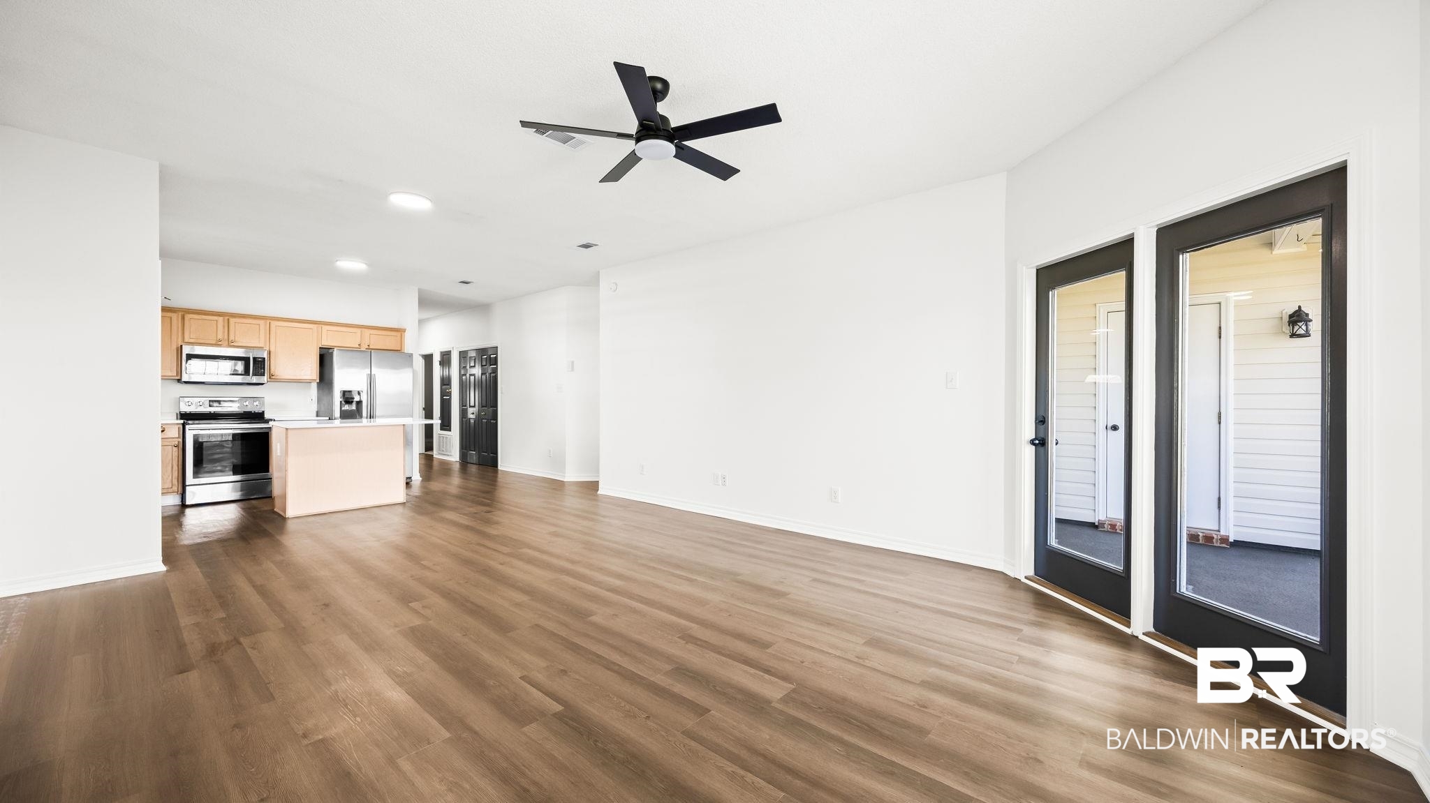 2651 South Juniper Street, Unit 705 Foley, AL 36535 - Photo 10 of 37 Spacious open-concept living area featuring wood-finish flooring and a black ceiling fan