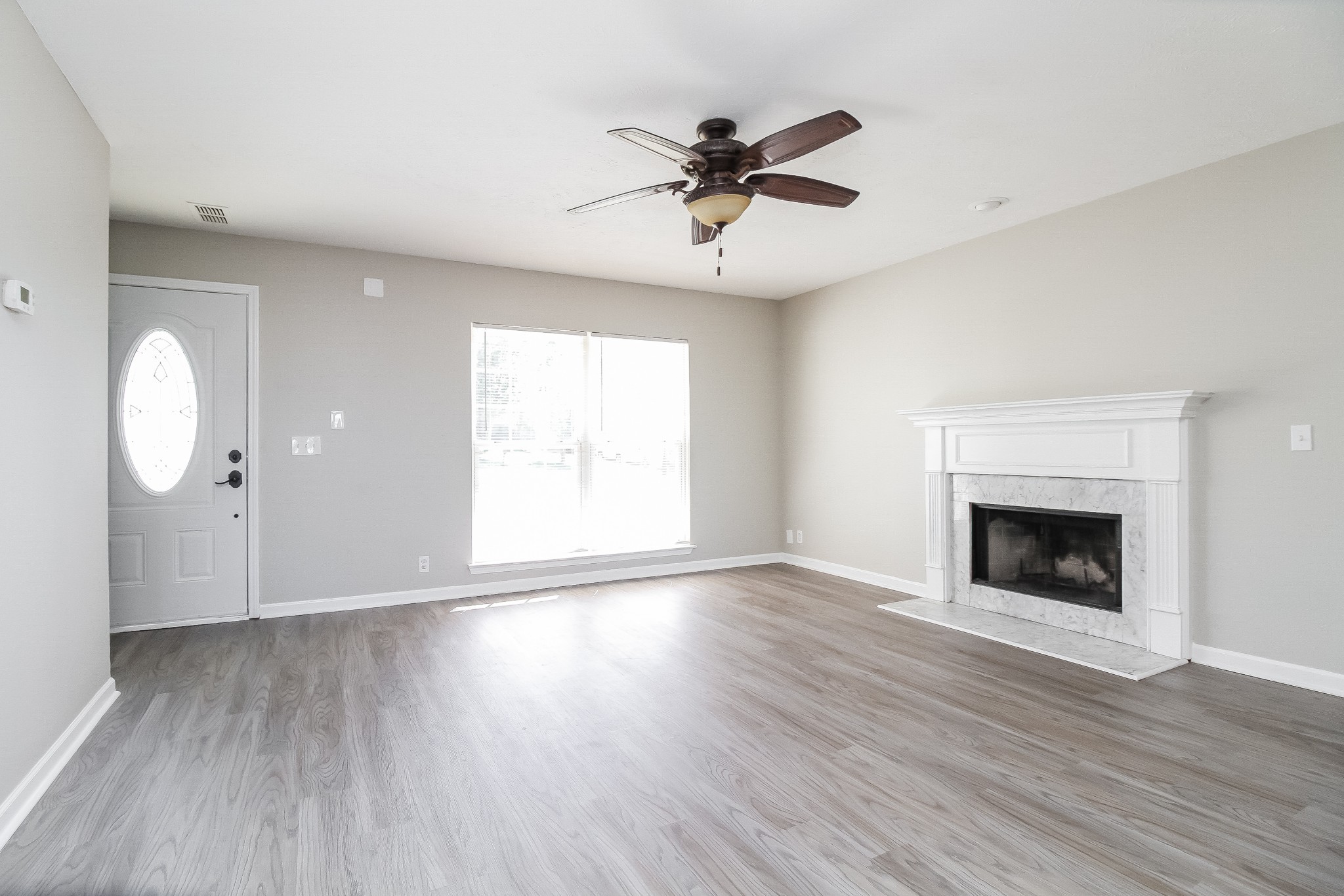 7015 Zither Lane La Vergne, TN 37086 - Photo 3 of 17 an empty room with wooden floor fan and windows