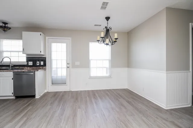 a view of a kitchen with a white cabinet and a stove top oven