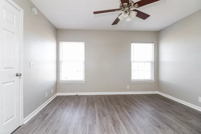 wooden floor in an empty room with a window