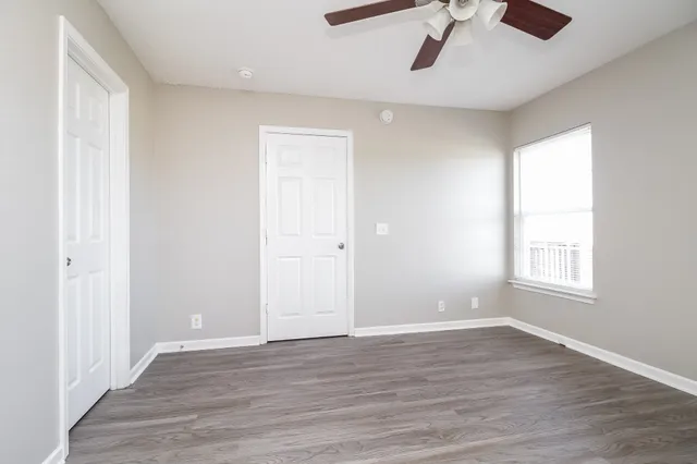 wooden floor in an empty room with a window
