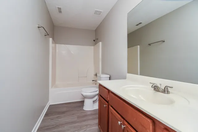 a bathroom with a sink toilet a vanity and bathtub
