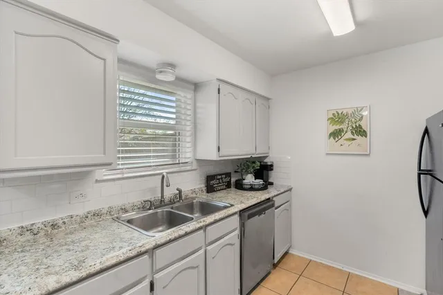 a kitchen with a sink cabinets and window