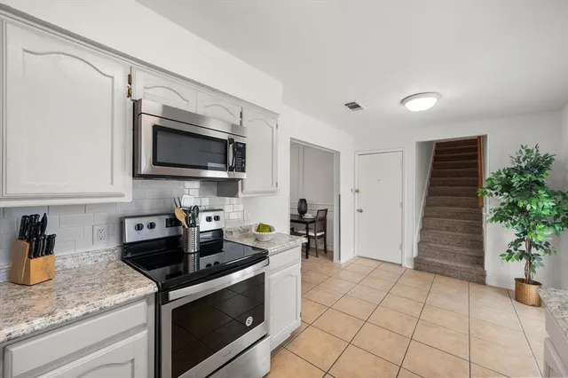 a kitchen with a sink and a stove top oven