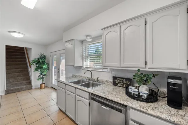 a kitchen with stainless steel appliances granite countertop a sink a stove a microwave and cabinets