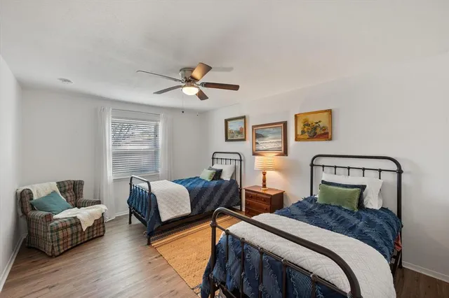 a bedroom with two beds and a couch