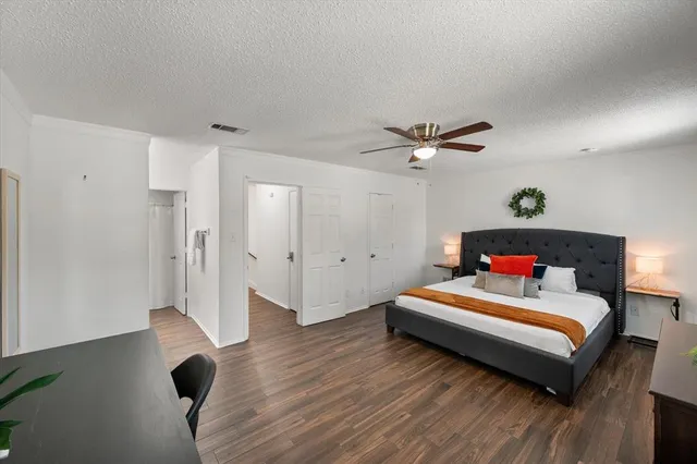 a bedroom with a bed and a ceiling fan