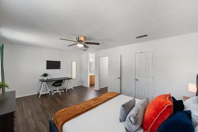 a bedroom with a bed and a desk