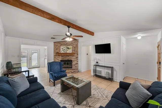 a living room with fireplace furniture and a flat screen tv