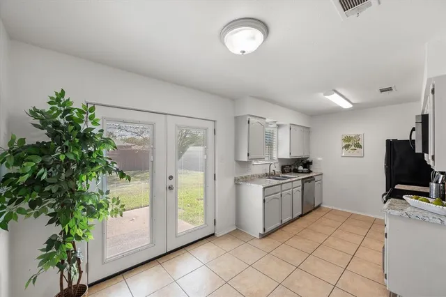 a kitchen with stainless steel appliances a sink and a stove