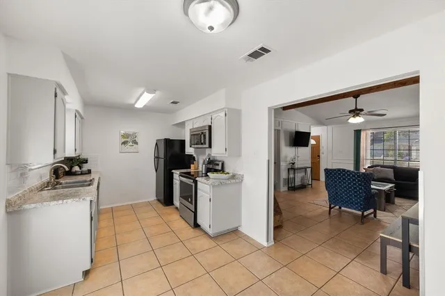 a kitchen with a sink and a stove top oven