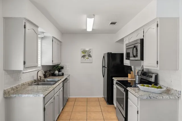 a kitchen with a sink stove and refrigerator
