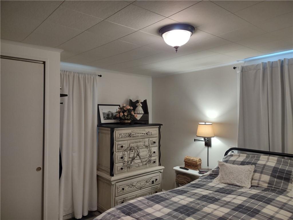 857 Mercer Grove City Road Mercer, PA 16137 - Photo 12 of 22 a bedroom with a bed and cabinets