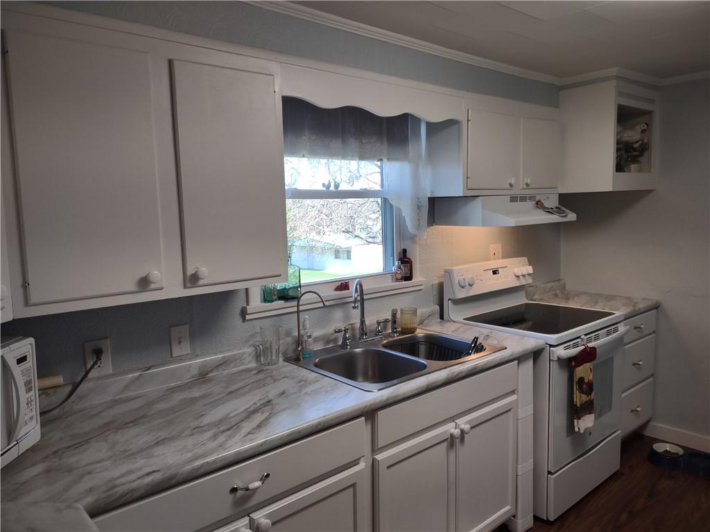 857 Mercer Grove City Road Mercer, PA 16137 - Photo 6 of 22 a kitchen with stainless steel appliances granite countertop a sink a stove and cabinets