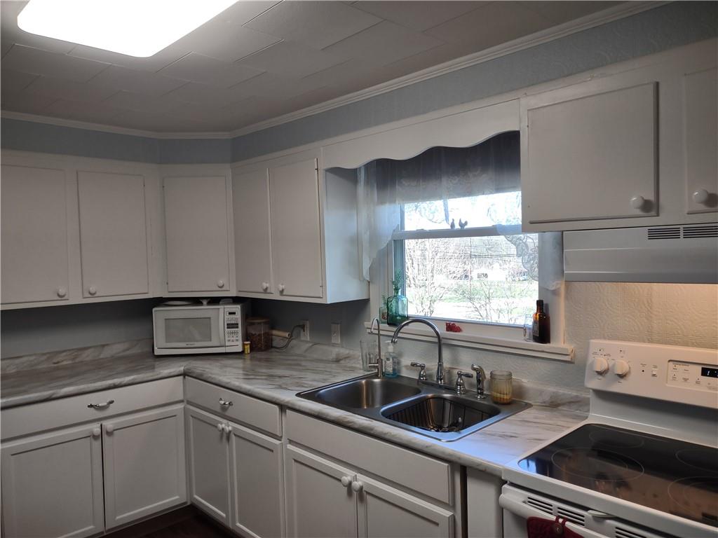 857 Mercer Grove City Road Mercer, PA 16137 - Photo 7 of 22 a kitchen with a sink and cabinets