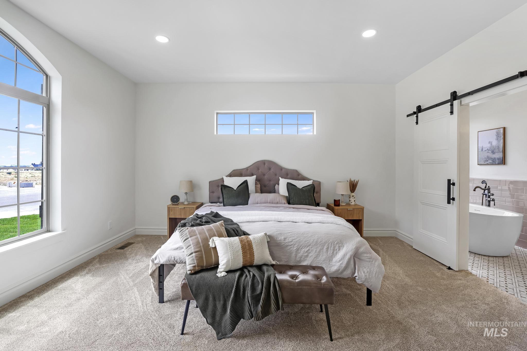 866 Quartz Road Kimberly, ID 83341 - Photo 21 of 48 Carpeted bedroom featuring a large arched window, a secondary rectangular window, and recessed ceiling lighting
