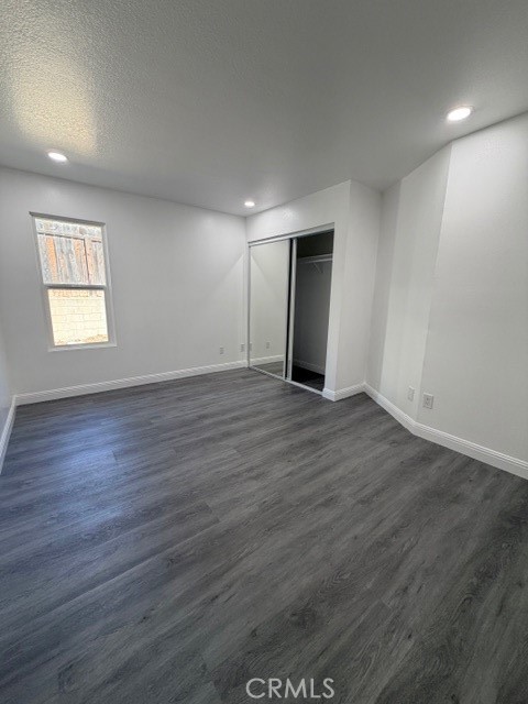 14744 Marymount Street Moorpark, CA 93021 - Photo 14 of 32 an empty room with wooden floor and windows