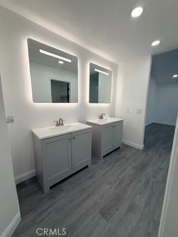 a room with two mirror and a wooden floor