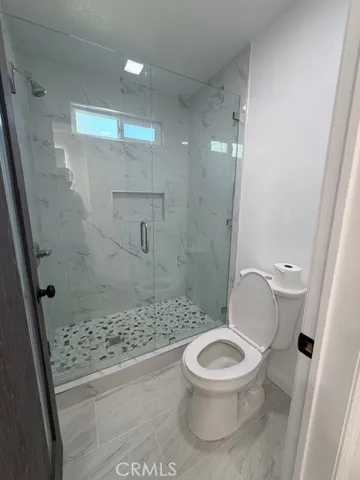 a white toilet sitting next to a bathroom sink