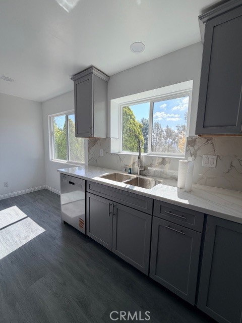 14744 Marymount Street Moorpark, CA 93021 - Photo 5 of 32 a kitchen with granite countertop white cabinets white appliances a sink and a large window