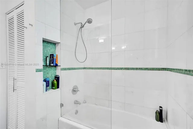 a bathroom with a bathtub and a shower