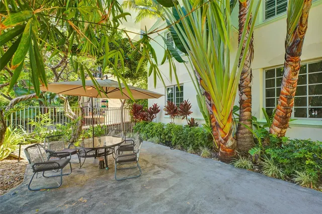 a view of a tables and chairs under an umbrella